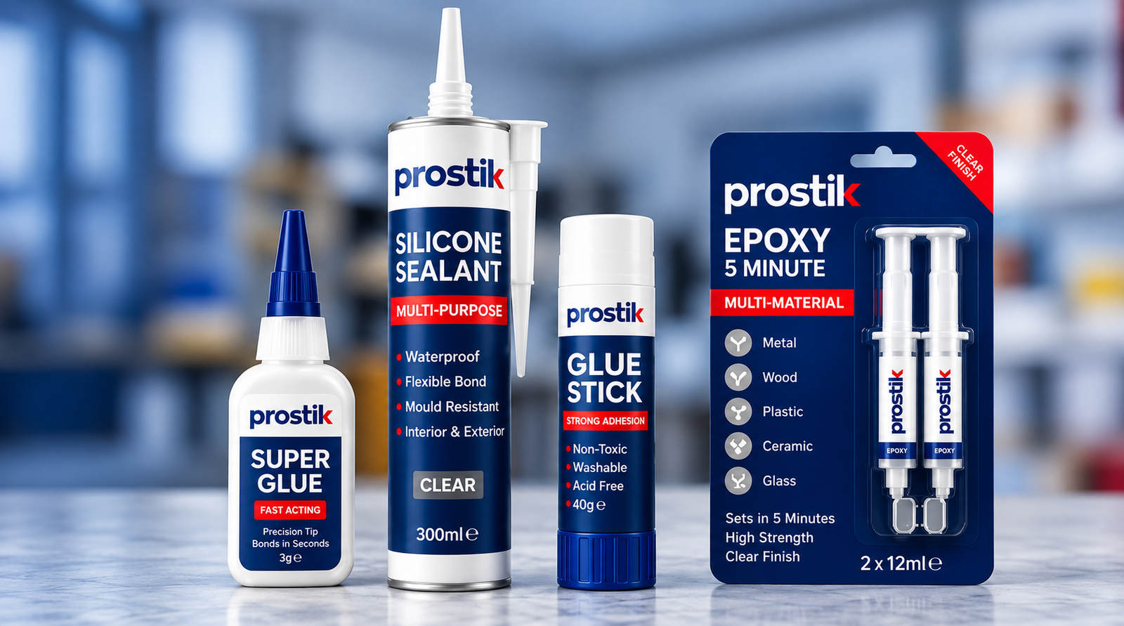 Range of Prostik adhesive and sealant products including super glue, silicone sealant, glue stick and epoxy, on a workshop bench